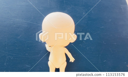 Baby gently placing his hand on the blue wall 113153576