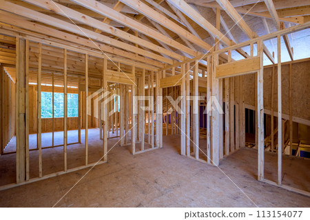 During construction of a new home, unfinished framing beams wooden house area used for construction 113154077