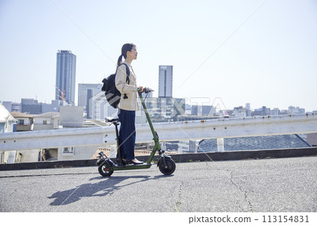 A Japanese woman traveling on an electric scooter A Japanese woman traveling on an electric scooter 113154831