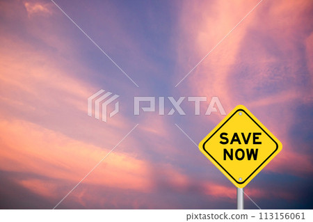 Yellow transportation sign with word save now on violet color sky background Yellow transportation sign with word save now on violet color sky background 113156061