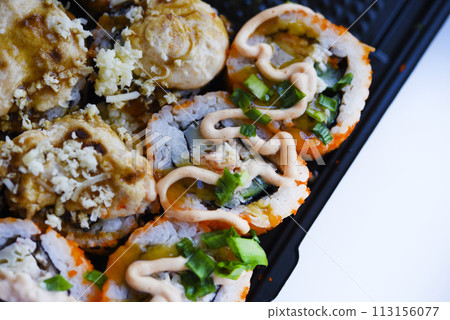 Fish rolls with sauce. Japanese sushi rolls. Rice breakfast of rolls. 113156077
