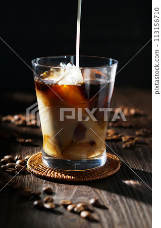 cold milk poured into iced coffee cold milk poured into iced coffee 113156710