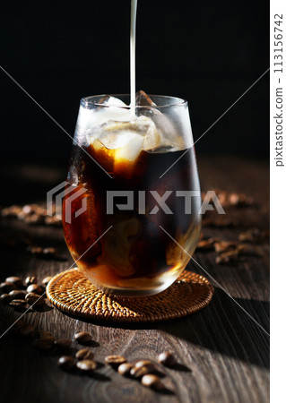 cold milk poured into iced coffee cold milk poured into iced coffee 113156742