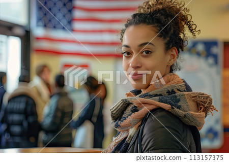 portrait Young mixed-race woman at polling station with US flag on wall behind 113157375