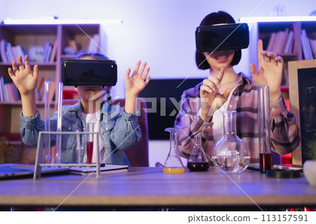 Daughter play with mom make funny experiment using vr glasses. 113157591