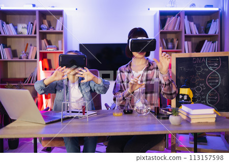 Daughter play with mom make funny experiment using vr glasses. 113157598
