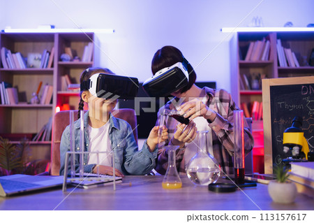 Caring young mother teaching small kid girl doing chemical experiments. 113157617