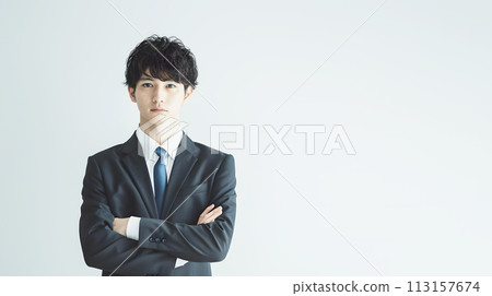 Businessman wearing a suit and folding his arms 113157674