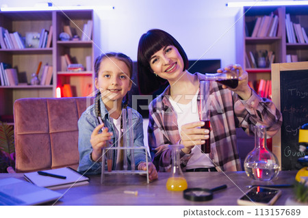 Happy two generations family involved in educational domestic activity. Happy two generations family involved in educational domestic activity. 113157689