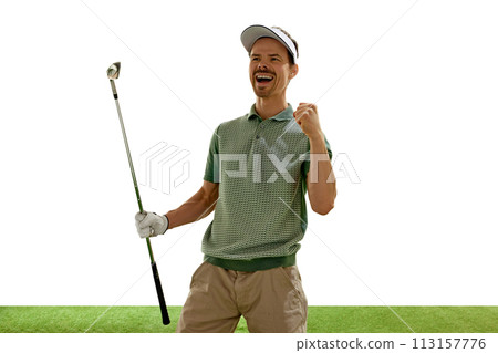Joyful golfer in retro outfit and cap celebrating perfect goal with raised fist and golf club stands on green court against white background. 113157776