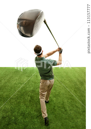 Professional golfer in retro outfit in mid follow-through with focus on club, green turf against white studio background. Professional golfer in retro outfit in mid follow-through with focus on club, green turf against white studio background. 113157777