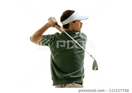 Rear view portrait of athlete in golf attire doing perfect swing in motion and looking at distance against white studio background. Rear view portrait of athlete in golf attire doing perfect swing in motion and looking at distance against white studio background. 113157788