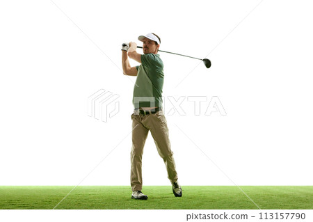 Full-body portrait of male golfer, skilled golf player performing tee shot against white studio background. 113157790