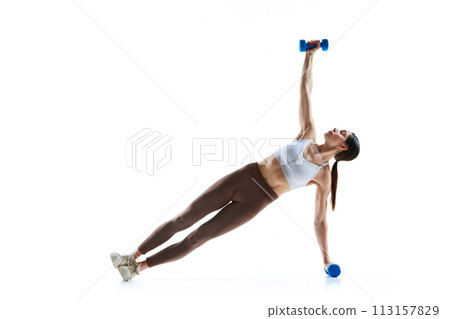 High plank T-Spine rotations with weights, dumbbells training against white studio background. Fat burning exercises. 113157829