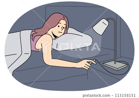 Woman lying in bed turn off lights 113158151