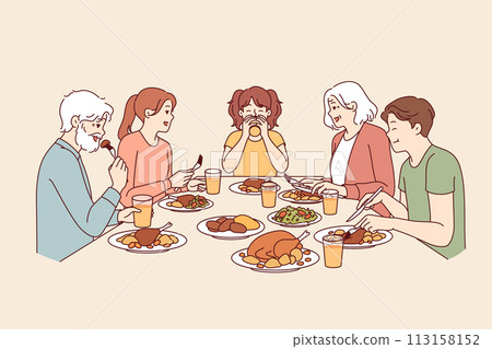 Large family has dinner together after completing religious fast, sitting around table with food 113158152
