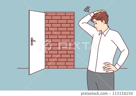 Business man is at dead end, looking for way to situation, standing near door blocked with bricks Business man is at dead end, looking for way to situation, standing near door blocked with bricks 113158250