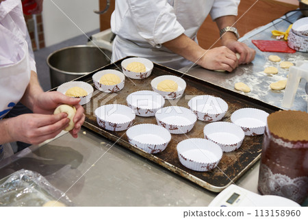 Bakers making buns for baking Bakers making buns for baking 113158960
