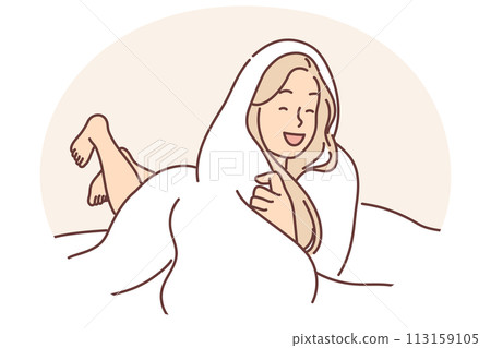 Laughing woman wrapped in blanket lies on bed not wanting to get up and go to work or college 113159105