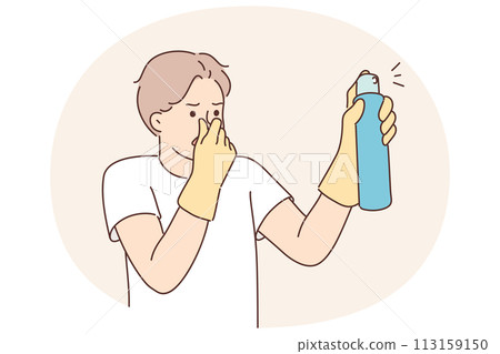 Dissatisfied man with spray to remove unpleasant odors covers nose with hand spraying freshener 113159150