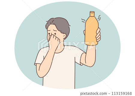 Man covers nose holding bottle of drink or milk that has expired and begun to ferment 113159168