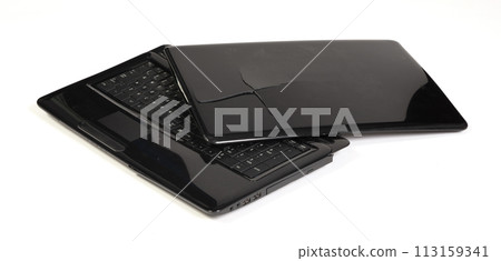 Old broken laptop isolated on white background Old broken laptop isolated on white background 113159341