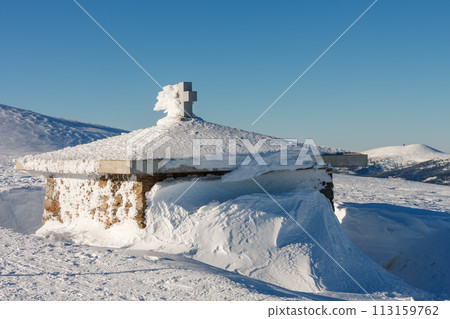 Stone chapel, memorial to the victims of the Giant Mountains,  Czech republic. Winter sunny day. 113159762