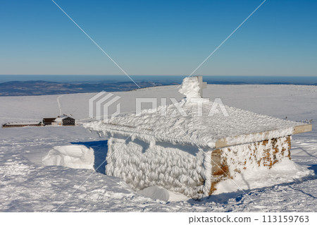 Stone chapel, memorial to the victims of the Giant Mountains,  Czech republic. Winter sunny day.On background Meadow Hut. 113159763