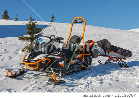 Snowmobile with stretcher mountain rescue service in front of cottage vyrovka in krkonose mountains. 113159767