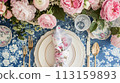 Table setting with rose flowers and candles for an event party or wedding reception in summer garden. 113159893