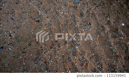 Sand on the beach covered with microplastics 113159941