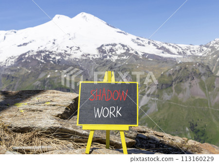 Shadow work psychology symbol. Concept words Shadow work on beautiful black chalk blackboard. Beautiful mountain Elbrus blue sky background. Psychology shadow work concept. Copy space. 113160229