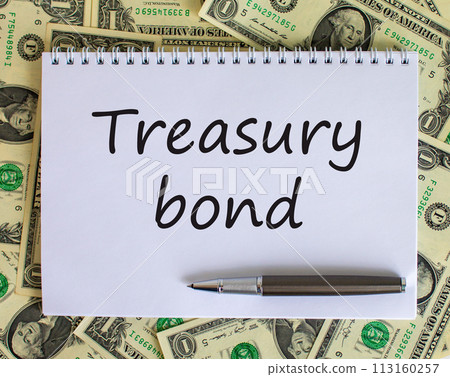 White note with space for your text on beautiful background from dollar bills and metalic pen. 'Treasury bond' text. Business concept. 113160257