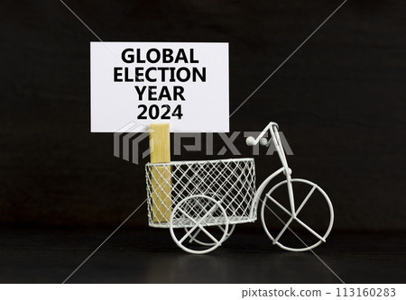 Global election year 2024 symbol. Concept words Global election year 2024 on beautiful white paper on clothespin. Beautiful black background. Business Global election year 2024 concept. Copy space 113160283