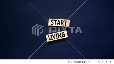 Start living symbol. Concept words Start living on beautiful wooden block. Beautiful black table black background. Business and Start living concept. Copy space. Start living symbol. Concept words Start living on beautiful wooden block. Beautiful black table black background. Business and Start living concept. Copy space. 113160303