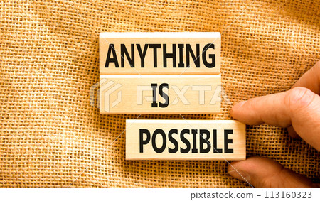 Anything is possible symbol. Concept words Anything is possible on beautiful wooden blocks. Beautiful canvas table canvas background. Businessman hand. Business anything possible concept. Copy space. 113160323