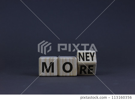 More money symbol. Turned the wooden cube and changed the concept word More to Money. Beautiful grey table grey background. Copy space. Business and more money concept. More money symbol. Turned the wooden cube and changed the concept word More to Money. Beautiful grey table grey background. Copy space. Business and more money concept. 113160356