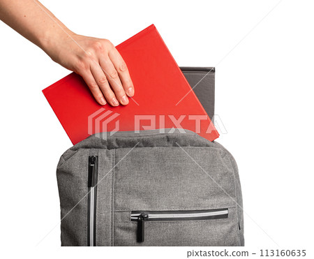 Hand putting books, textbooks into backpack, schoolbag isolated on white background 113160635