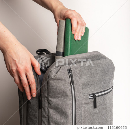 Packing books, planners, notebooks into backpack Packing books, planners, notebooks into backpack 113160653