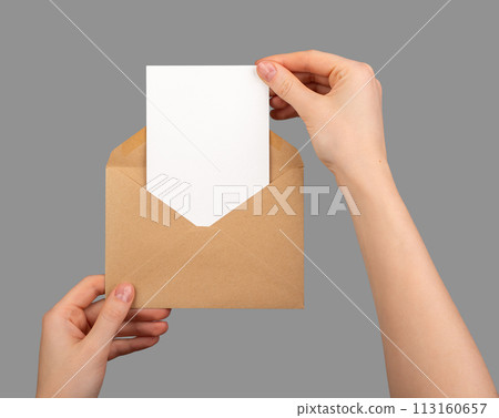 Postcard mockup, vertical blank card taking from paper envelope isolated on white Postcard mockup, vertical blank card taking from paper envelope isolated on white 113160657