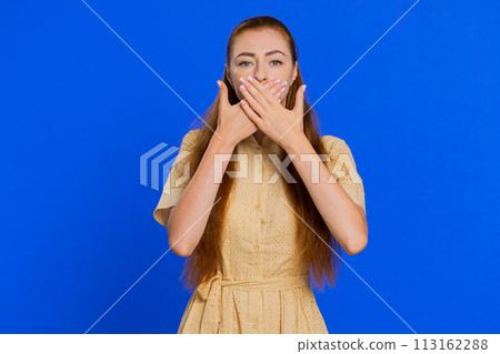 Frightened woman closing mouth with hands refusing to tell terrible secret, unbelievable truth 113162288