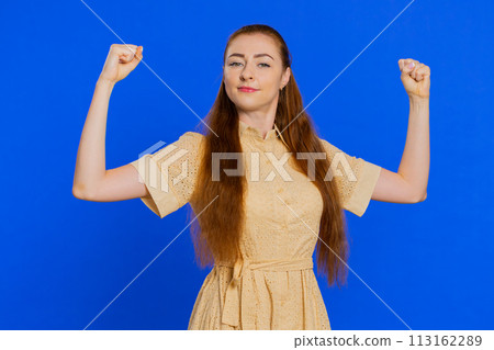Woman showing biceps and looking confident, feeling power strength to fight for rights, success win 113162289