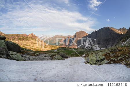 Snowy sunny stony pass, large colorful mountain range Snowy sunny stony pass, large colorful mountain range 113162548
