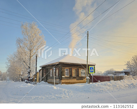 Rustic wooden house under the snow. Rural street. 113162552