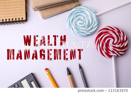 WEALTH MANAGEMENT. Office items on a white table WEALTH MANAGEMENT. Office items on a white table 113163870