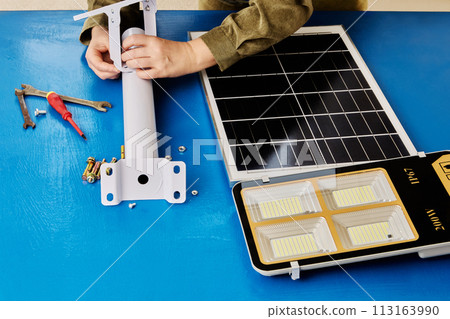 DIY assembly of mounting bracket for holder of solar panel and an LED street light. 113163990