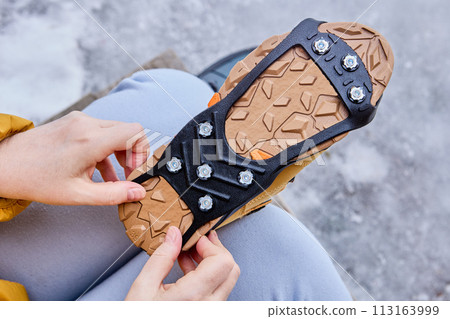 Stainless steel spikes for traction on ice and snow in form of rubber overlay for boots. 113163999