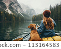 Rear view of woman paddles her canoe 113164583