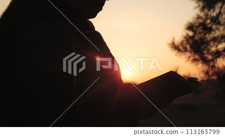 girl woman praying at sunset, hand sunset faith pain, asking heaven for help, bible book, tranquil sunset praying, young woman spirituality, divine connection sunset, spiritual growth dusk 113165799