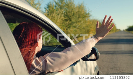 girl rides car with her hand out window, traveling together family during summer holidays, hand movements from window sunset, girl waving her hand from car window, happy family concept. man window car girl rides car with her hand out window, traveling together family during summer holidays, hand movements from window sunset, girl waving her hand from car window, happy family concept. man window car 113165892